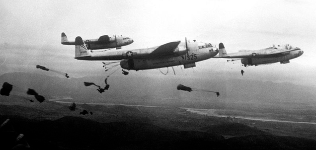 Paratroopers of the 187th Airborne Regimental Combat Team jump out of U.S. Air Force Fairchild C-119 Flying Boxcars over Korea in 1950.
